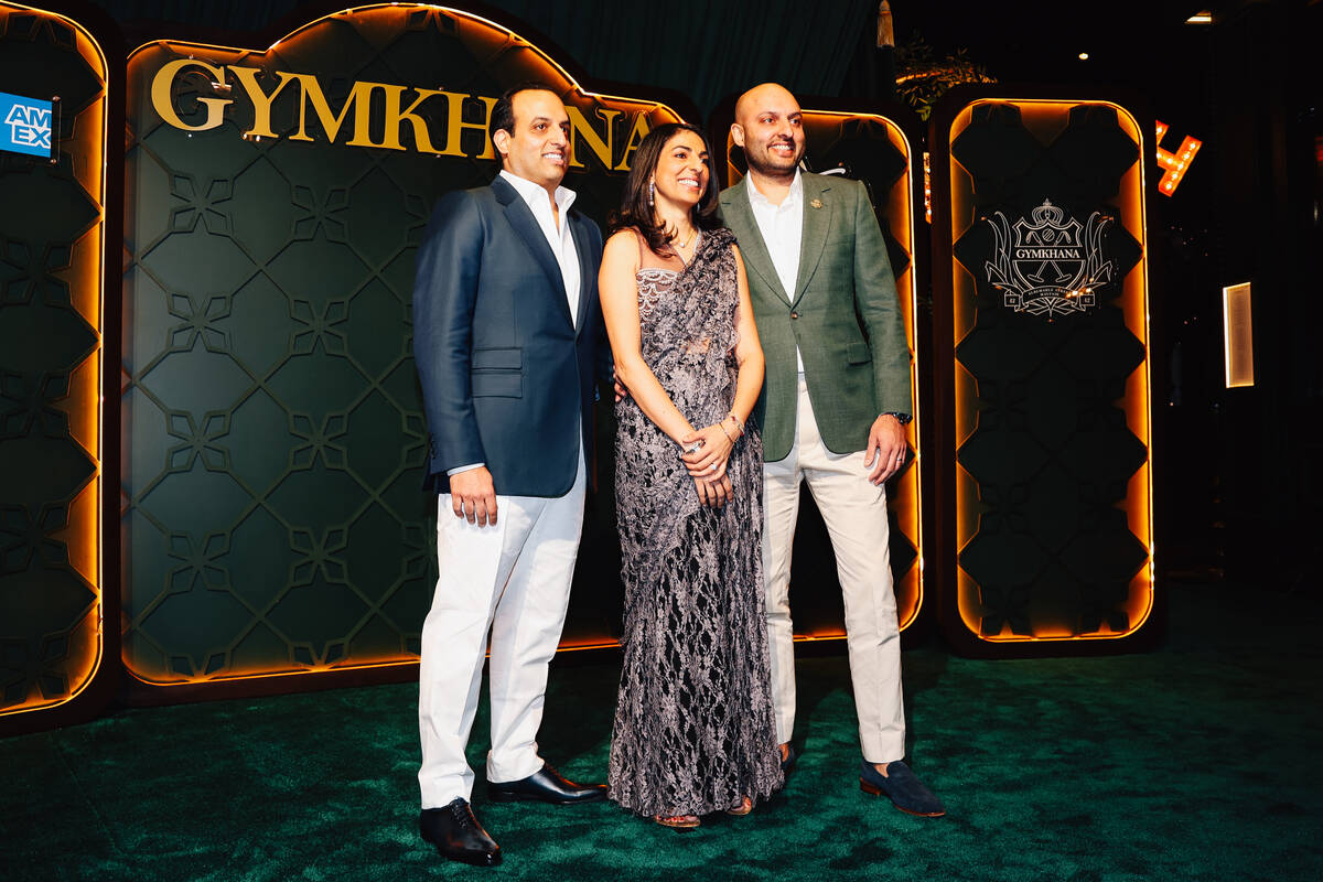 Karam Sethi, from left, poses with Jyotin Sethi and Sunaina Sethi on a red carpet during the op ...