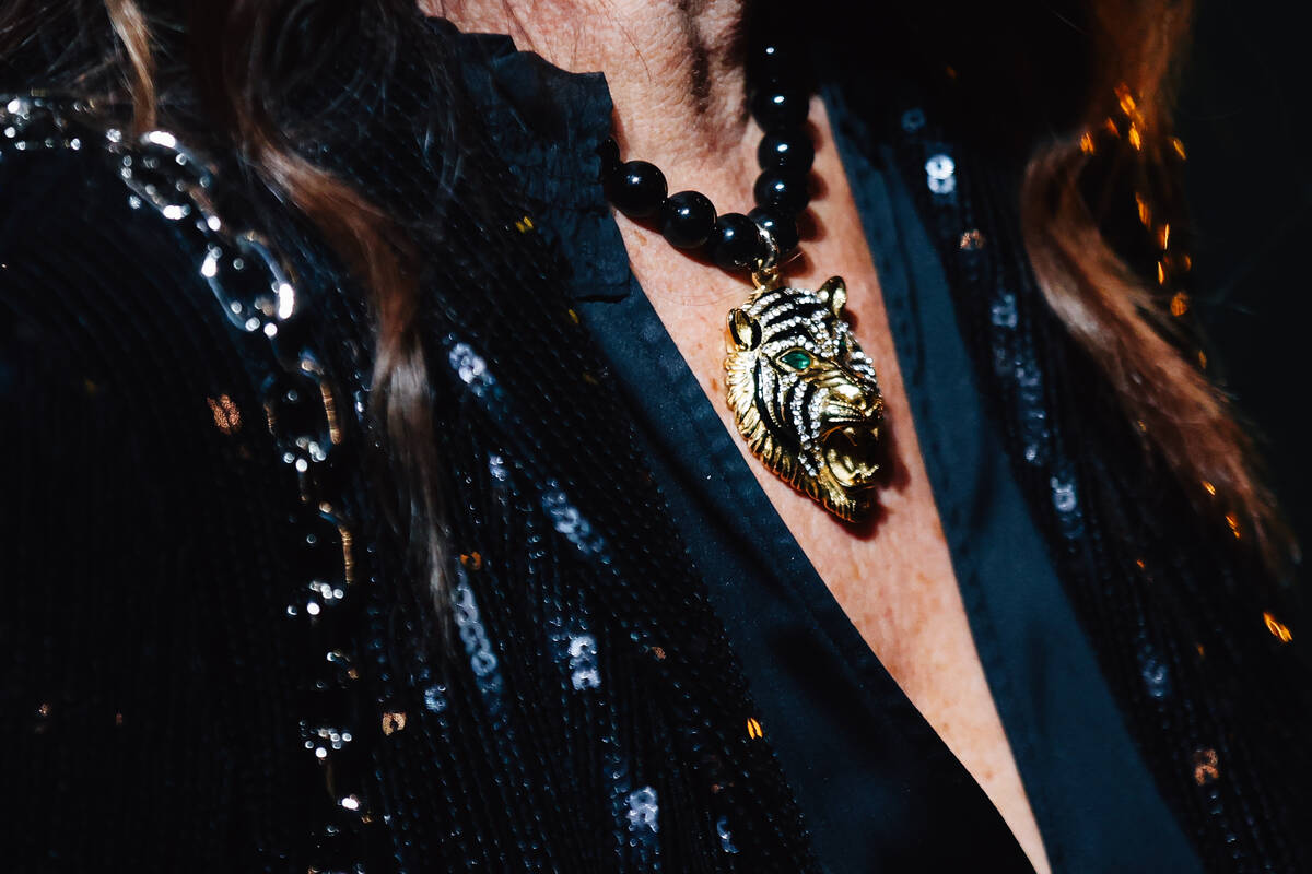 A guest wears a tiger necklace on a red carpet during the opening party at Gymkhana in the Aria ...