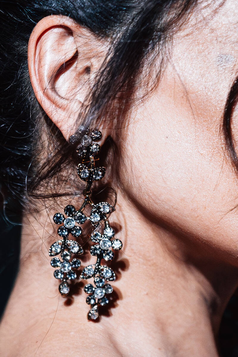 A guest wears jewelry on a red carpet during the opening party at Gymkhana in the Aria Friday, ...