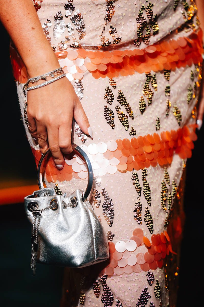A guest holds a purse on a red carpet during the opening party at Gymkhana in the Aria Friday, ...