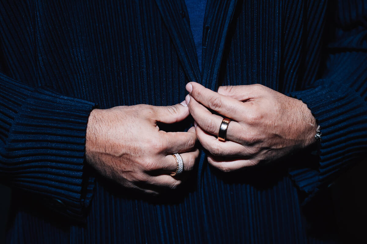 A guest buttons their jacket on a red carpet during the opening party at Gymkhana in the Aria F ...
