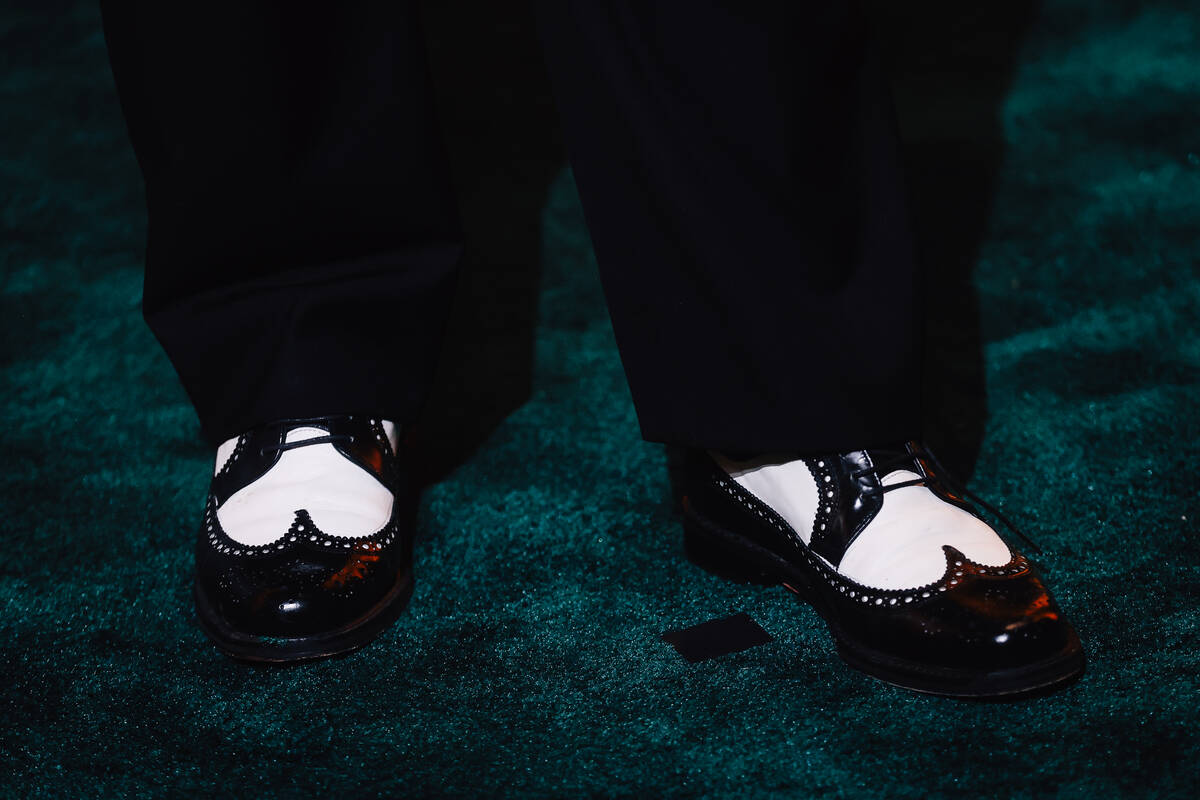 Shoes on a red carpet during the opening party at Gymkhana in the Aria Friday, Jan. 16, 2026, i ...