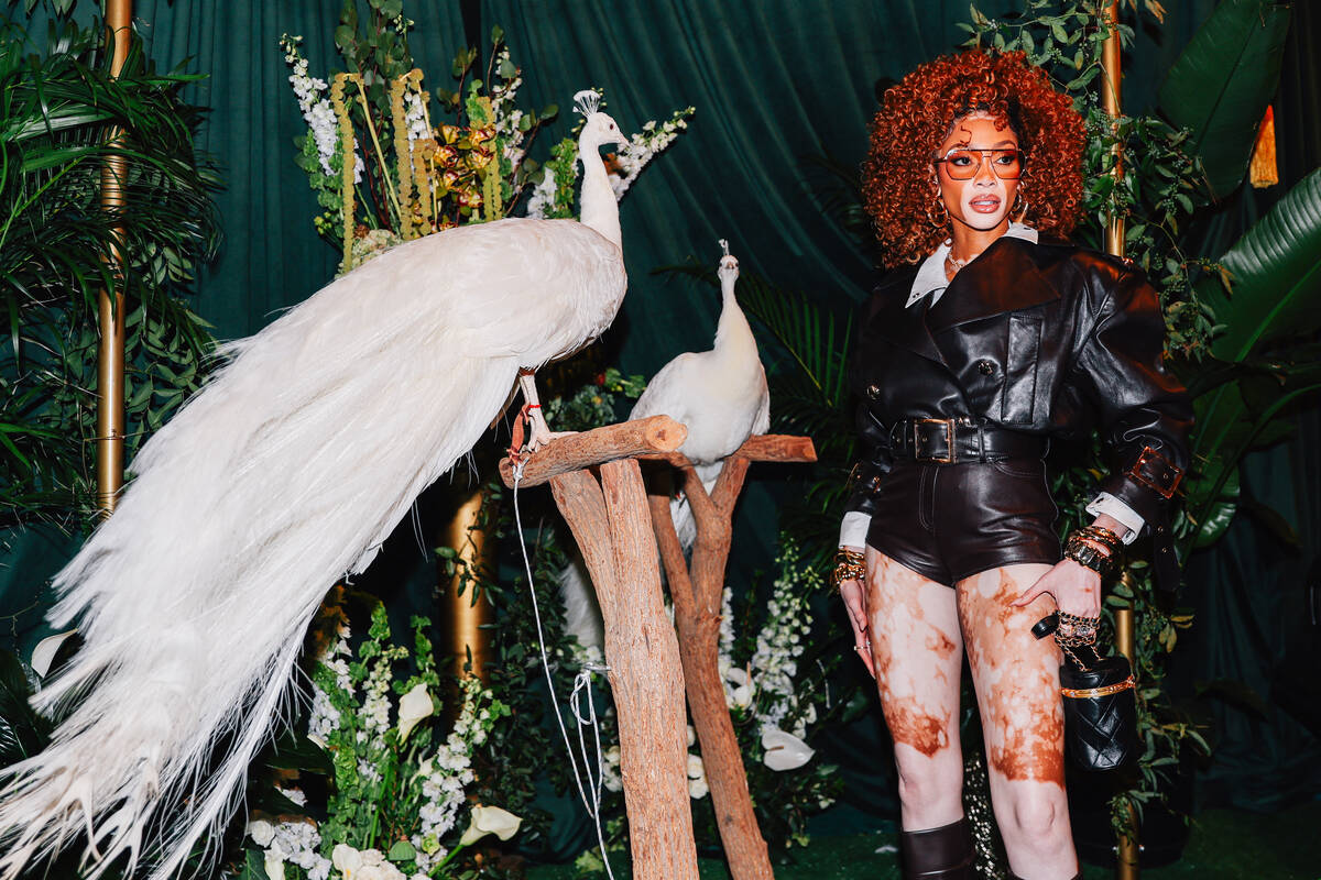 Model Winnie Harlow poses with peacocks on a red carpet during the opening party at Gymkhana in ...