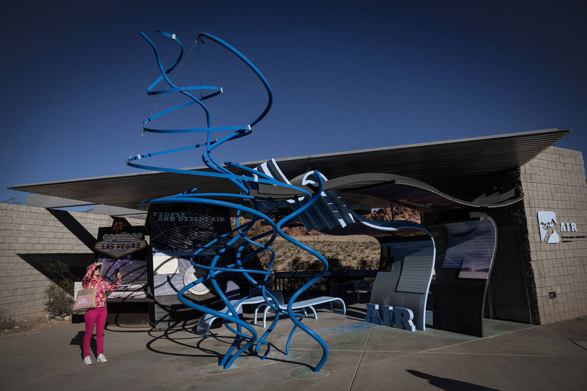 People take photos with art installations at the visitors center at Red Rock Canyon National Co ...