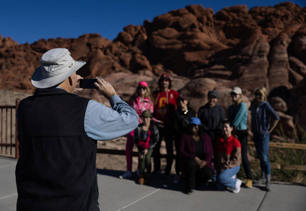 Adventure tour guide Mike Metzger takes a photo of clients at Red Rock Canyon National Conserva ...