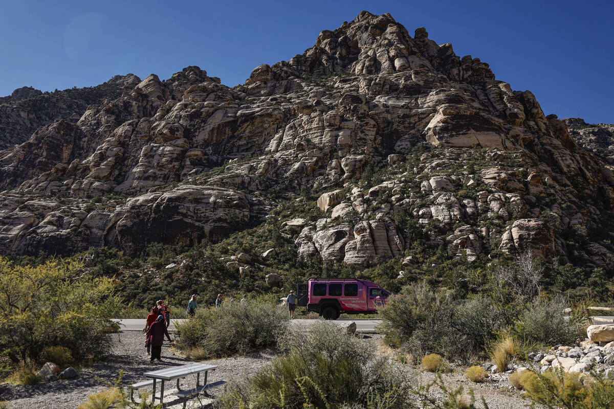 Clients walk back to a Pink Jeep Tour vehicle at Red Rock Canyon National Conservation Area Tue ...