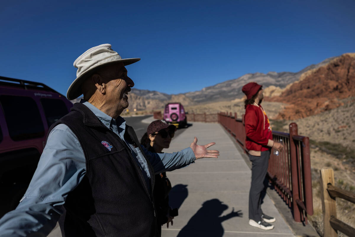 Adventure tour guide Mike Metzger, left, points out significant elements of Red Rock Canyon Nat ...