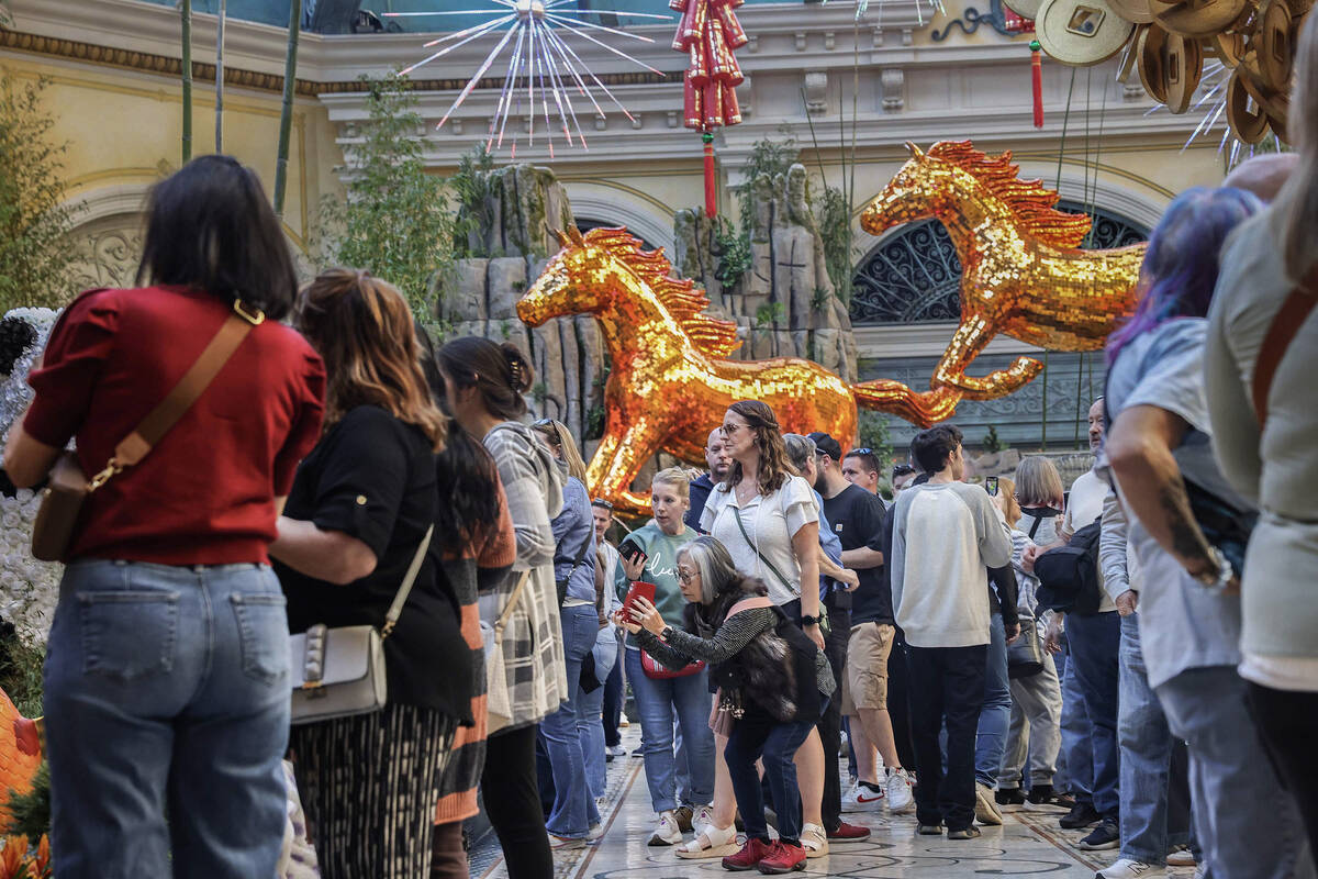 People walk through the recently installed Lunar New Year display at the Bellagio Conservatory ...