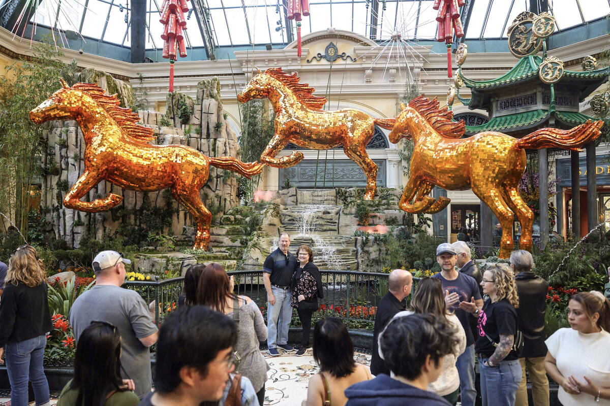 People walk through the recently installed Lunar New Year display at the Bellagio Conservatory ...