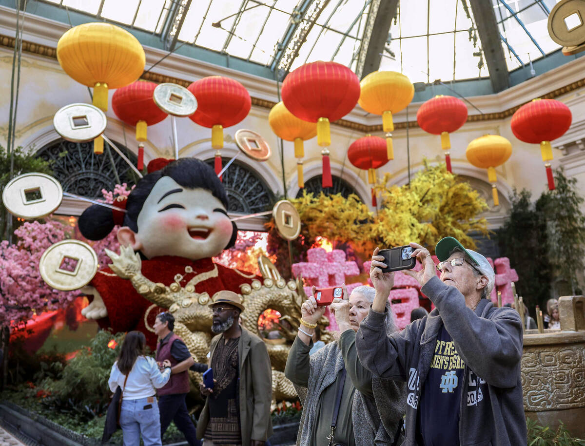 People walk through the recently installed Lunar New Year display at the Bellagio Conservatory ...