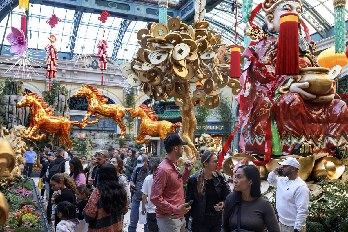 People walk through the recently installed Lunar New Year display at the Bellagio Conservatory ...