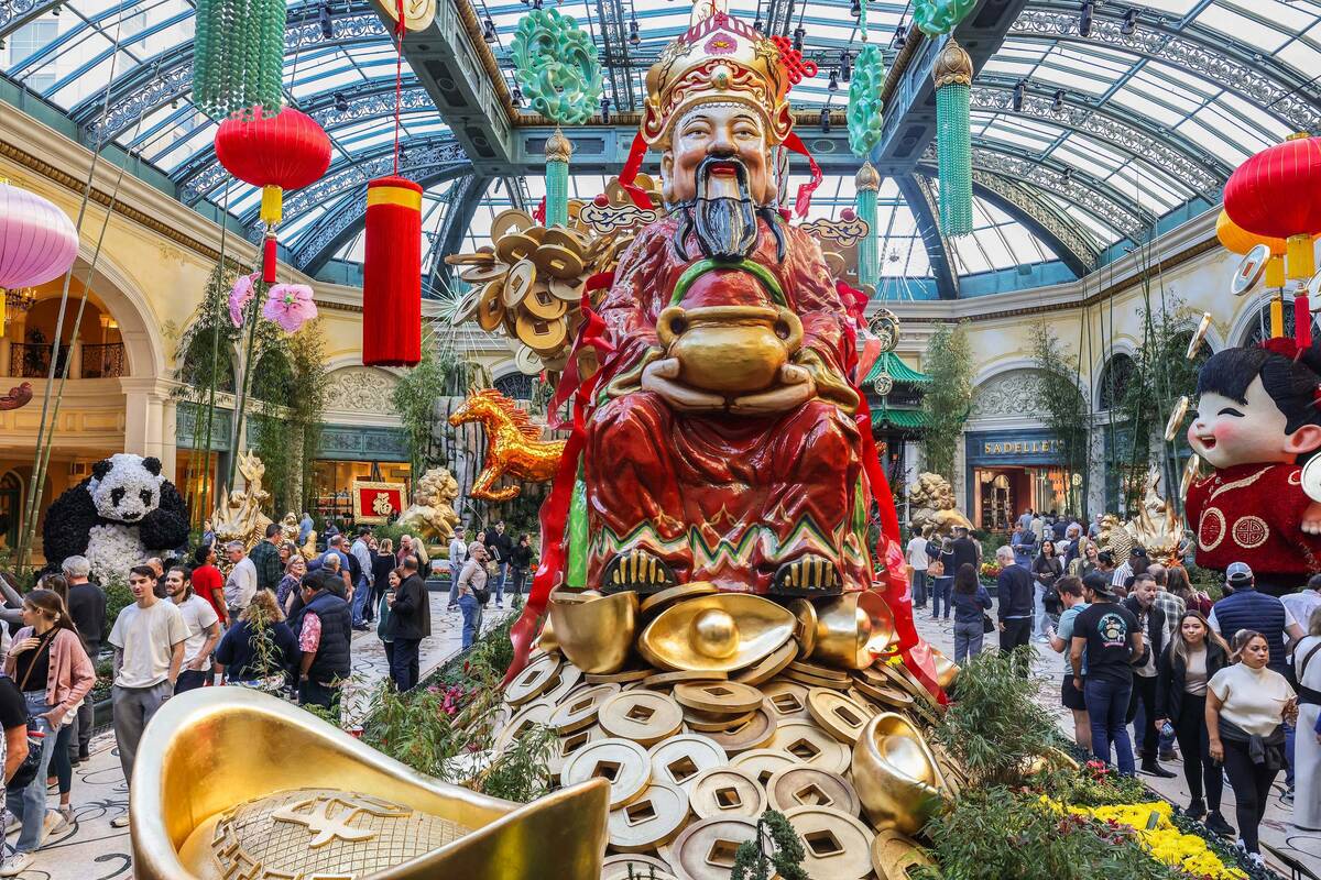 People walk through the recently installed Lunar New Year display at the Bellagio Conservatory ...