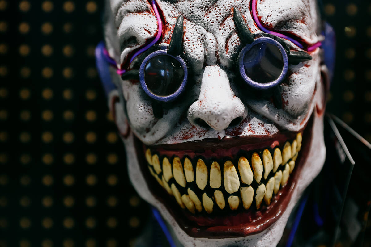 A mask grins from its display during the Halloween and Costume Association’s Second Annu ...