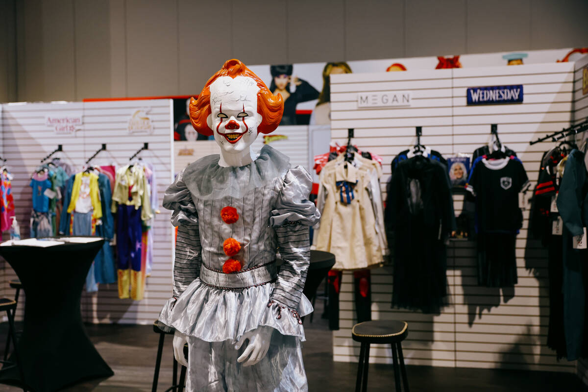 A Pennywise costume stands amid clusters of licensed costumes at the Rubies booth during the Ha ...