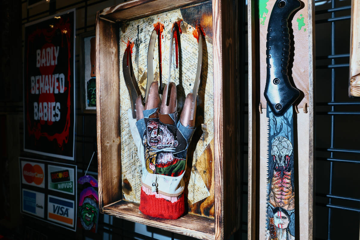 A hand-painted glove portraying Freddy Krueger sits on display the Killer Art Co. booth during ...