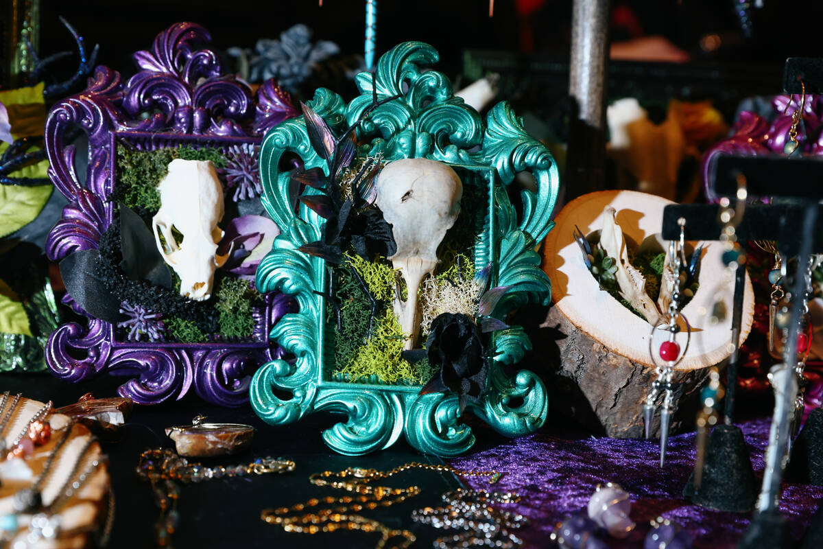Amid handmade jewelry of crystal and bone, frames decorated with real animal skulls sit for sal ...