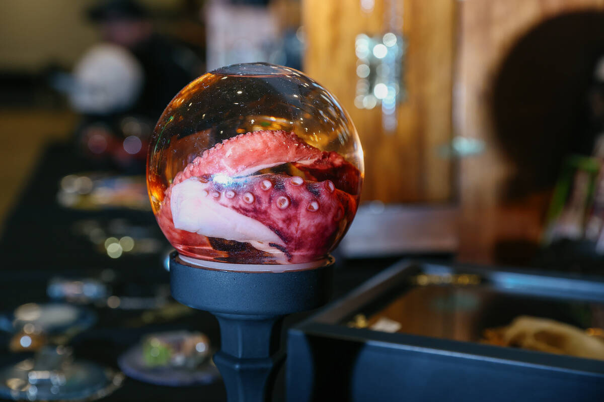 A mummified octopus tentacle sits suspended in liquid at the Dealer of the Dead booth during Da ...