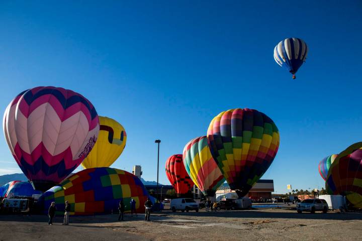 Balloons prepare for flight near CasaBlanca Resort at the Mesquite Balloon Festival on Friday, ...