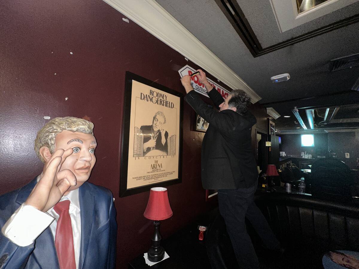 Harry Basil is shown during disassembling the wall art after “Last Laughs at the Trop” at t ...