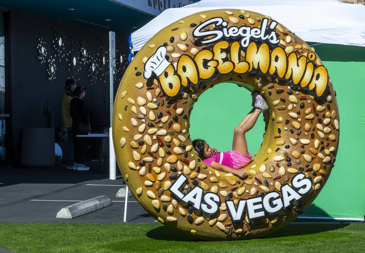 Marseille Sotto, 7, of Las Vegas chills in a giant bagel statue as the world’s top-ranke ...