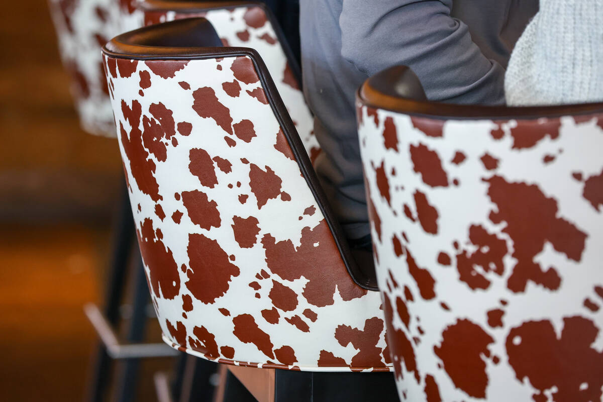Diners at the bar sit in cow hide patterned chairs on Friday, Dec. 5, 2025 at Guy Fieri's ...