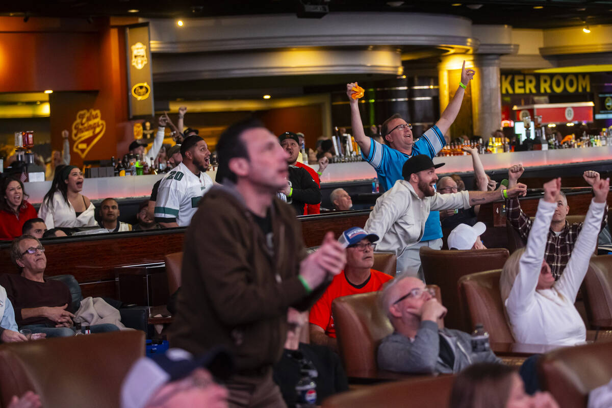 Philadelphia Eagles fans and bettors react to a touchdown against the Kansas City Chiefs while ...