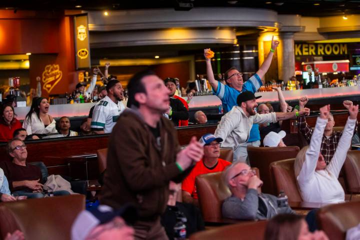 Philadelphia Eagles fans and bettors react to a touchdown against the Kansas City Chiefs while ...