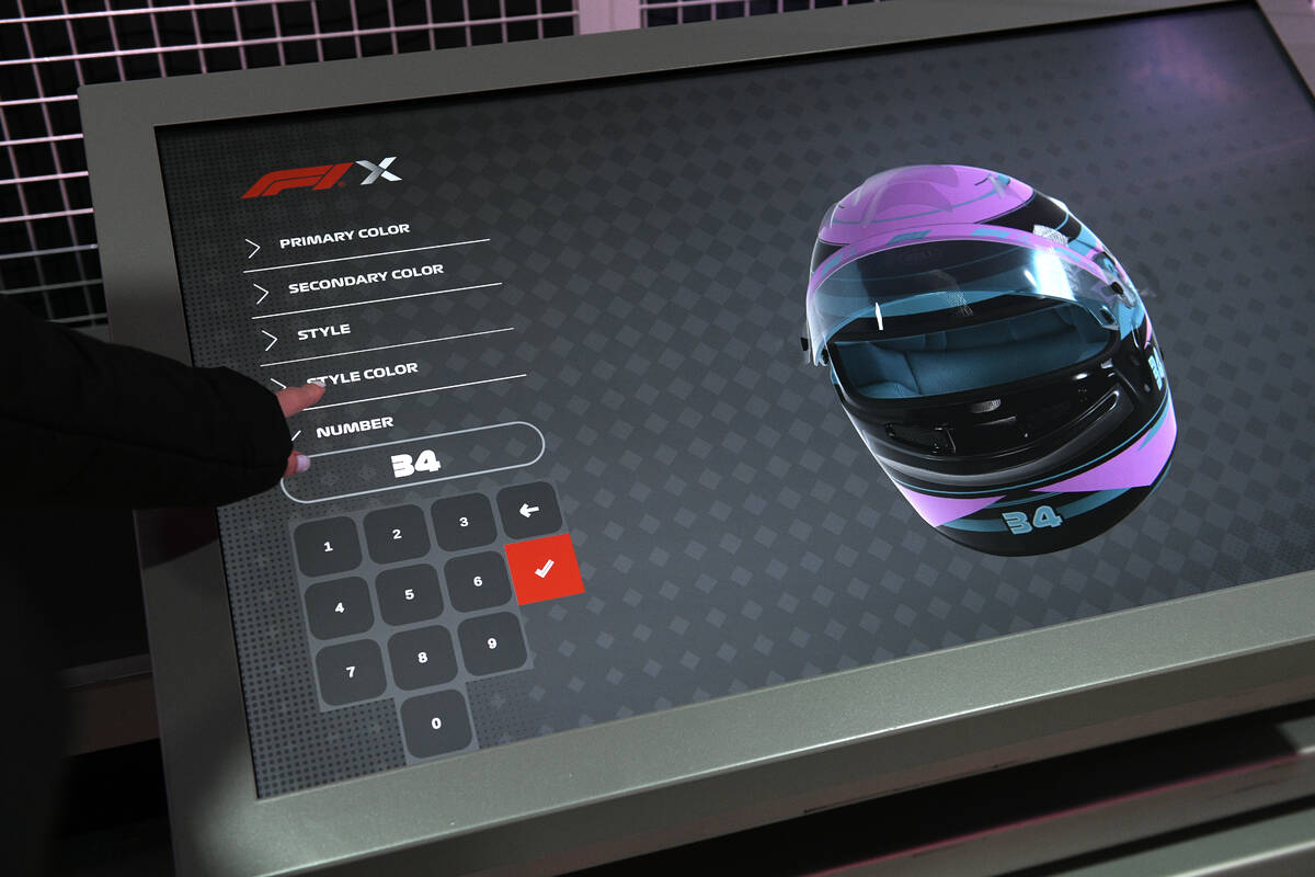 A guest designs their own racing gear during the reopening of Grand Prix Plaza Friday, January ...