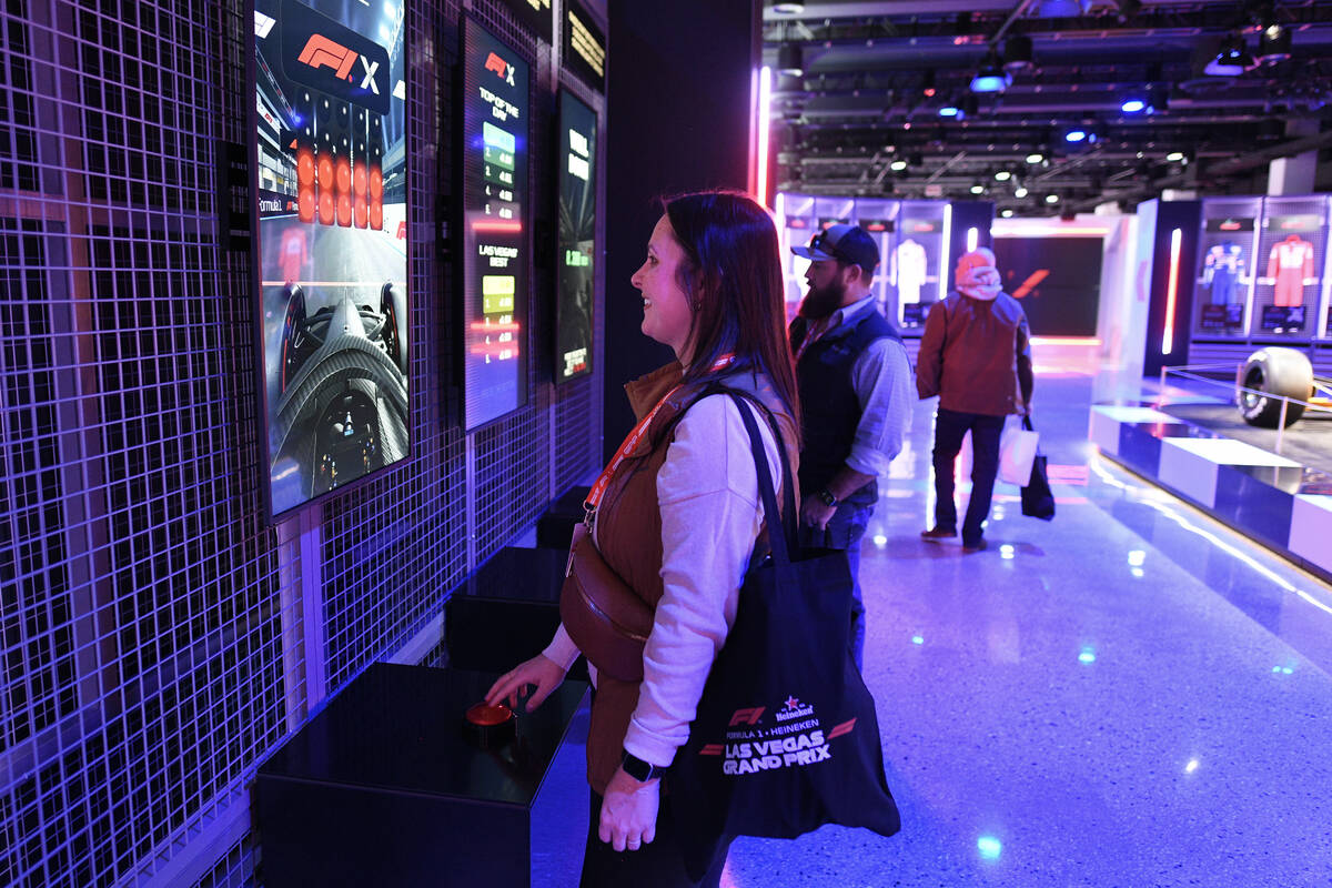 Marissa Maguire from Waco, Texas, tries out a reaction game during the reopening of Grand Prix ...