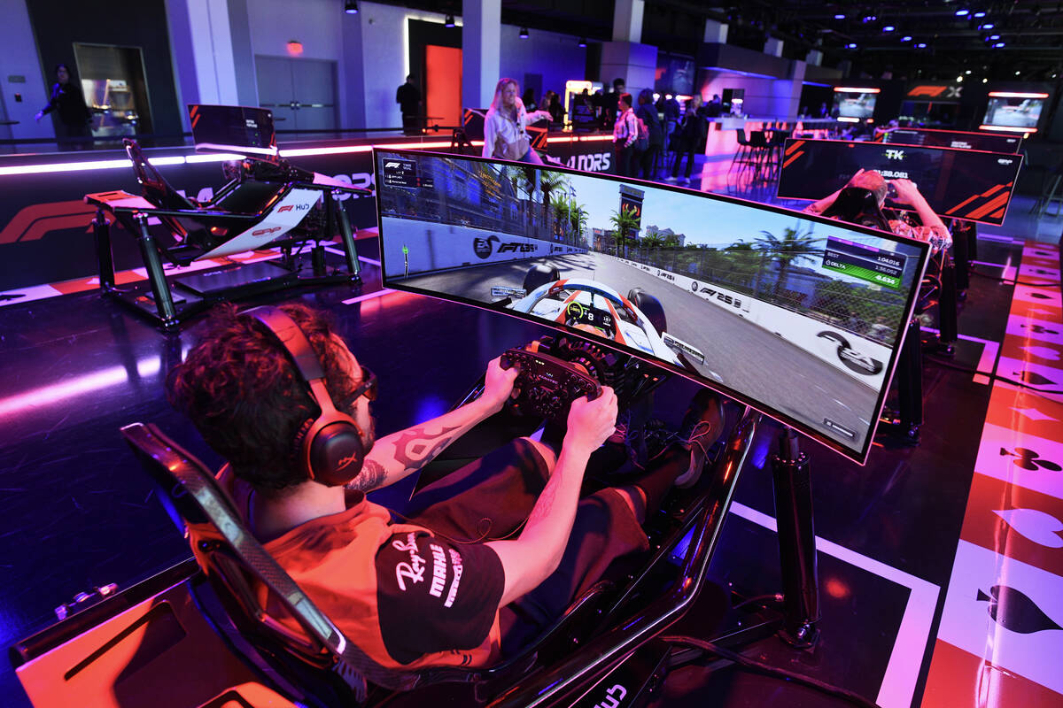 Alex Garcia from Las Vegas drives an F1 simulator during the reopening of Grand Prix Plaza Frid ...