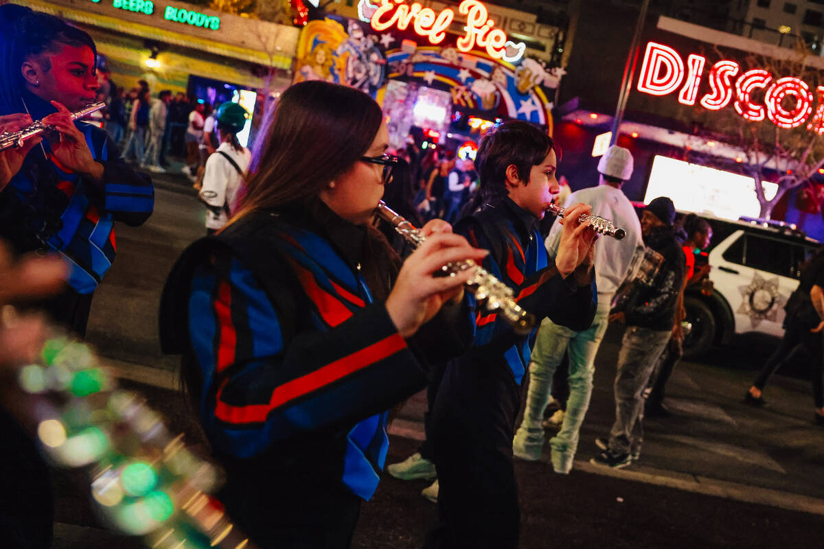 The Legacy High School Marching Band marches down Fremont Street during a pop-up event promotin ...