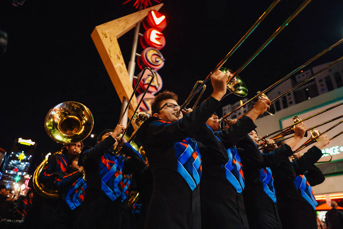 The Legacy High School Marching Band marches down Fremont Street during a pop-up event promotin ...