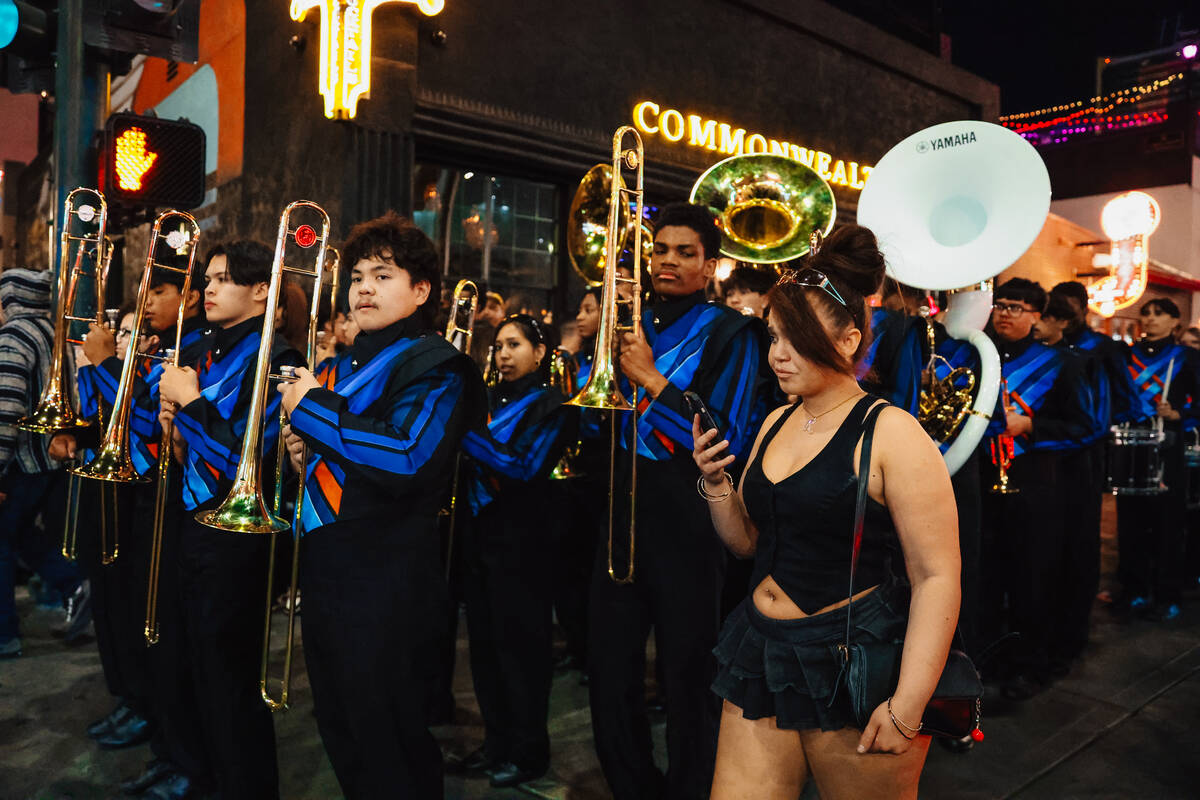 The Legacy High School Marching Band marches down Fremont Street during a pop-up event promotin ...