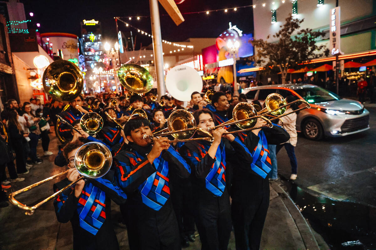 The Legacy High School Marching Band marches down Fremont Street during a pop-up event promotin ...