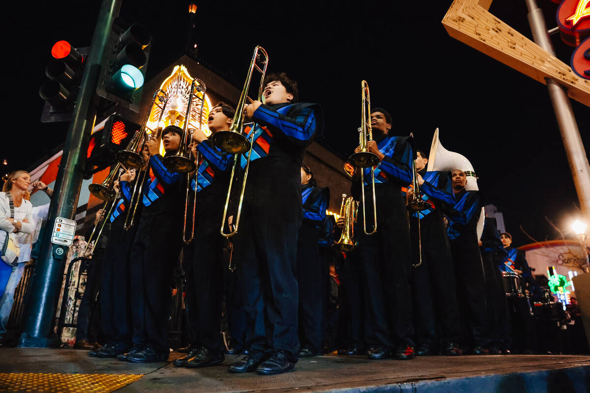 The Legacy High School Marching Band marches down Fremont Street during a pop-up event promotin ...