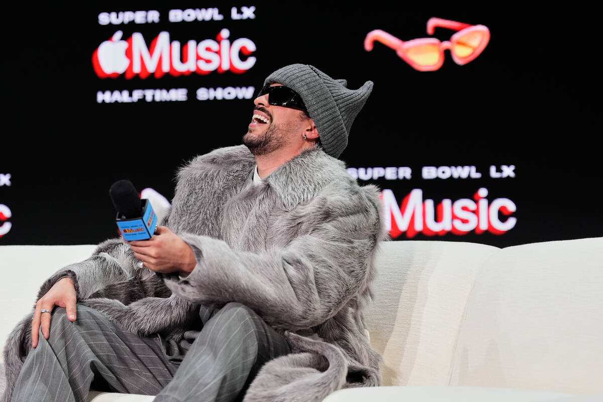 Apple Music Super Bowl LX Halftime Show performer Bad Bunny laughs during a news conference, Th ...
