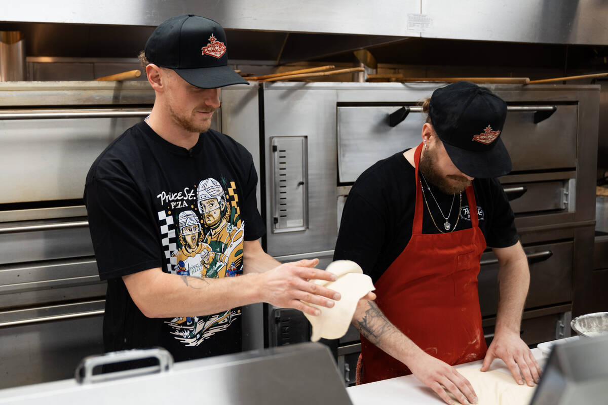 Golden Knights center Jack Eichel (left) prepares dough at Prince St. Pizza's Serene Avenue loc ...