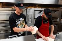Golden Knights center Jack Eichel (left) prepares dough at Prince St. Pizza's Serene Avenue loc ...