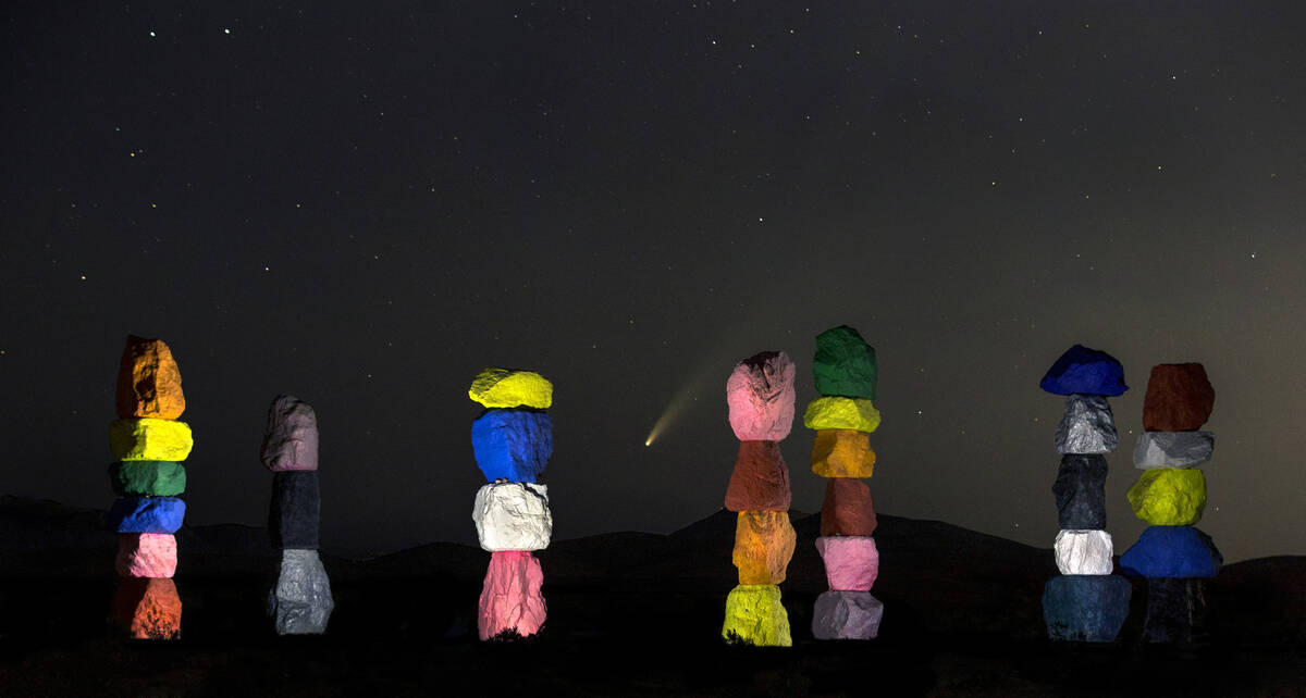 Comet NEOWISE streaks across the sky above the Seven Magic Mountains art installation on Wednes ...
