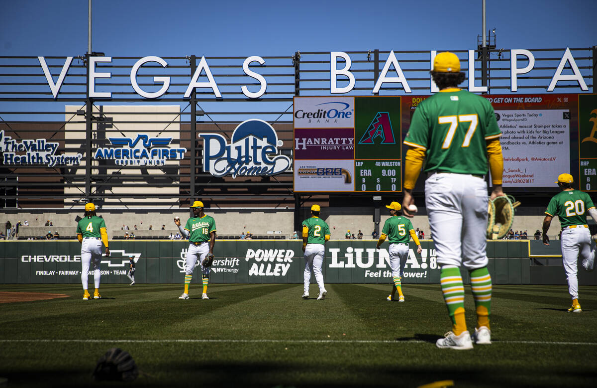 Athletics players warm up before playing the Arizona Diamondbacks during a Big League Weekend b ...