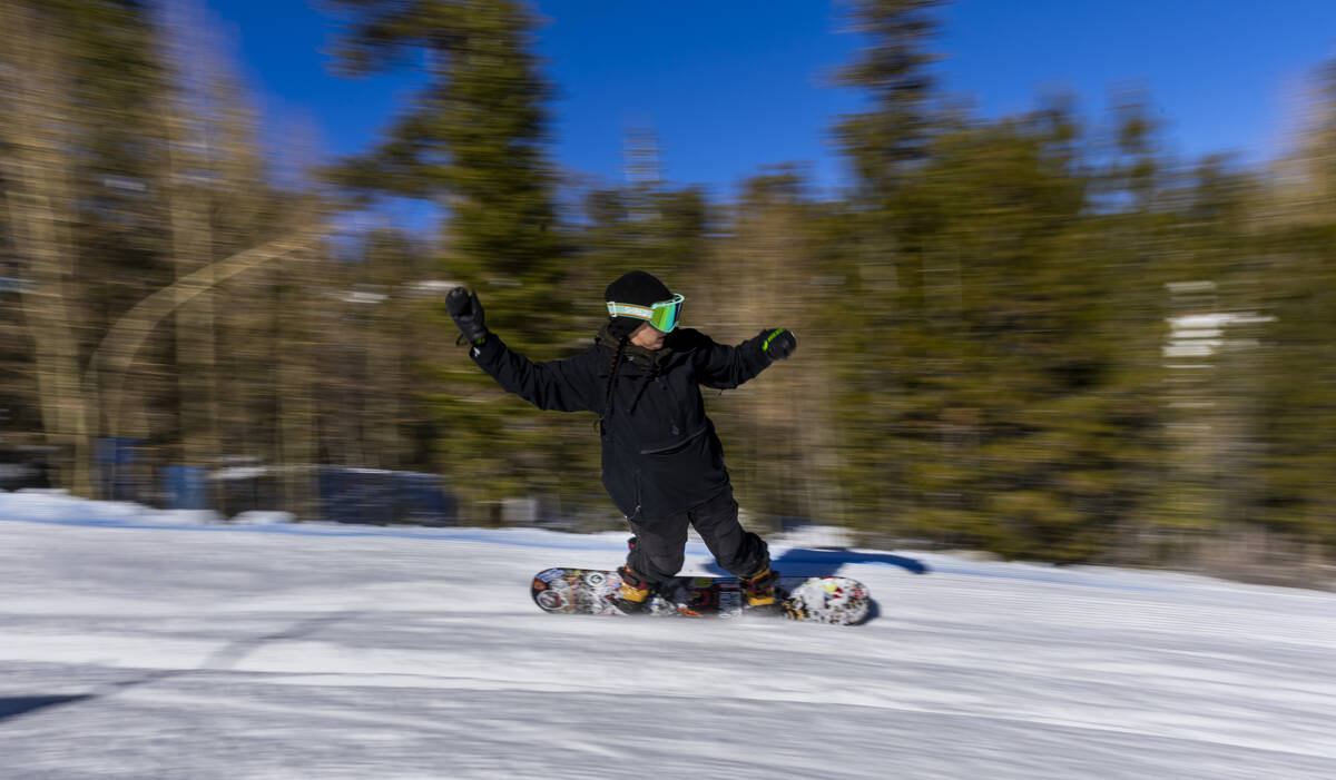 Beverly White catches an edge on her snowboard as she races down a course at Lee Canyon on Satu ...