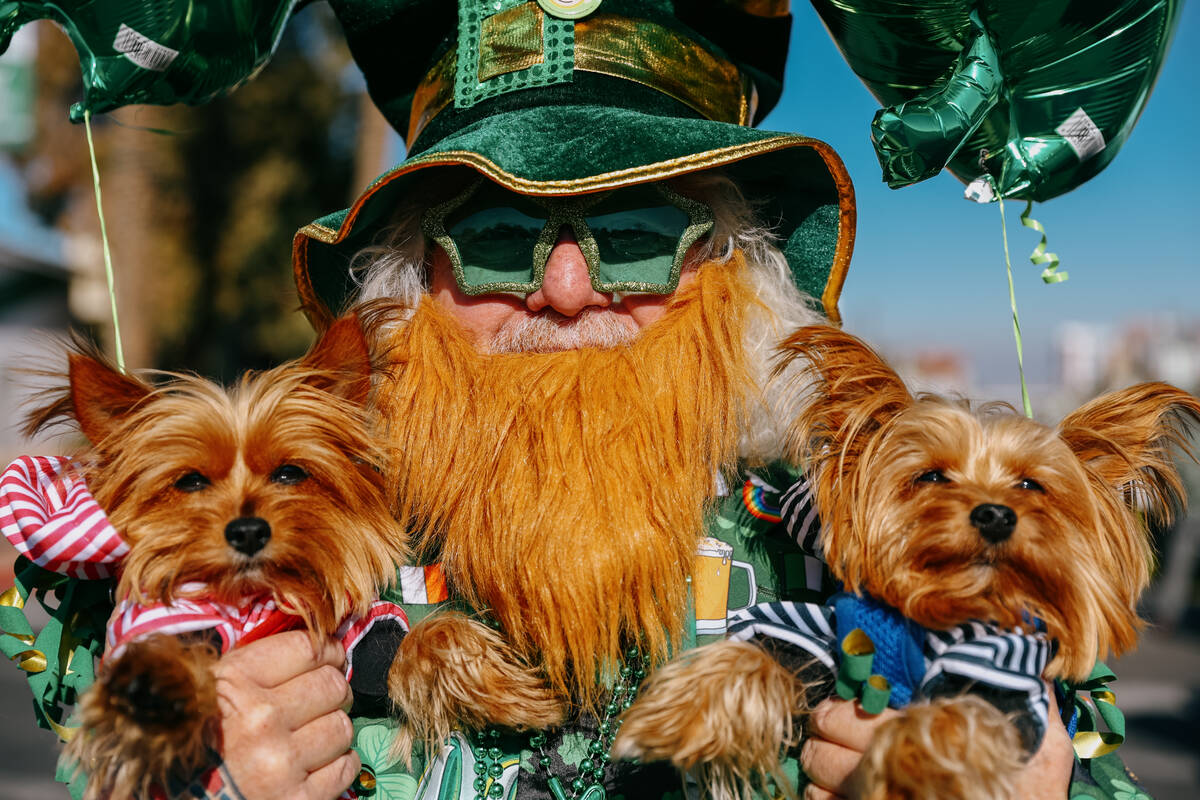 Danny Brooks holds his two three-year-old dogs, Kandi, left, and Biggie Smalls, right, ahead of ...