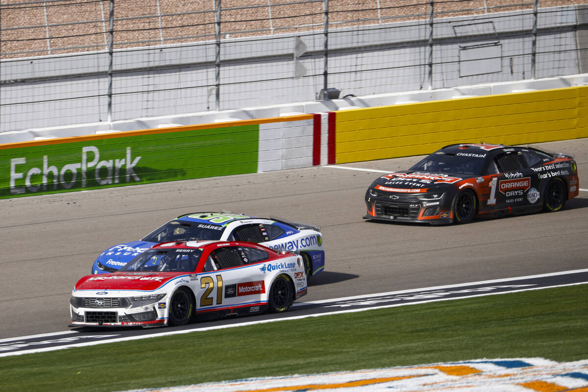 Driver Josh Berry (21) gets ahead of Daniel Suarez (99) to take the lead in the final laps of t ...