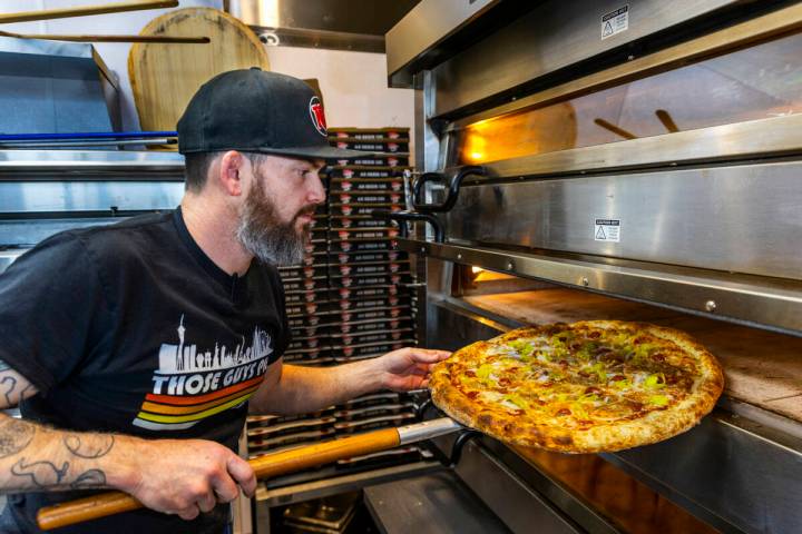 Chris Builder, co-founder and co-owner, checks on the baking as he prepares a Big Sexy pie at T ...