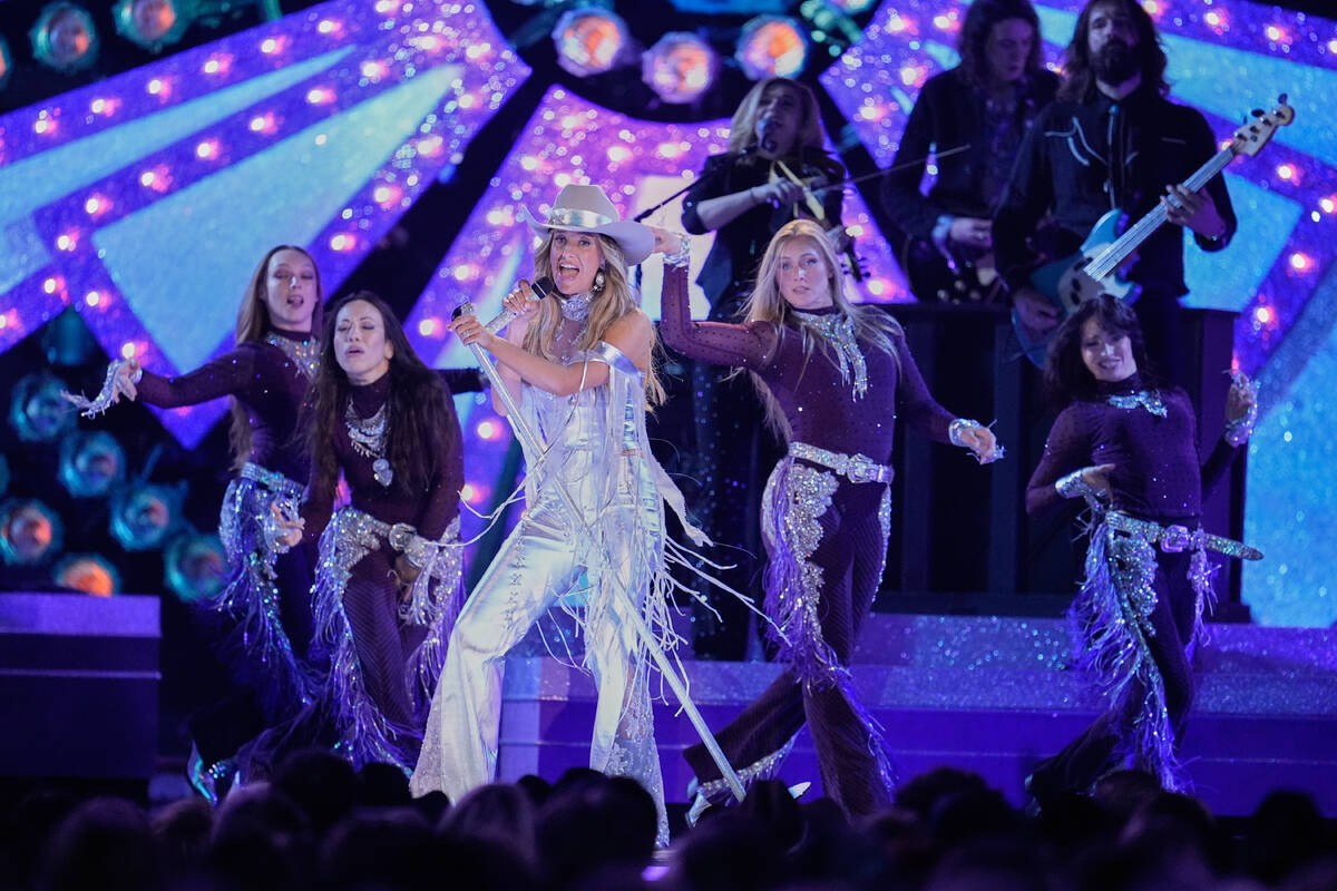 Lainey Wilson, center, performs "Ring Finger" during the 59th Annual Country Music As ...