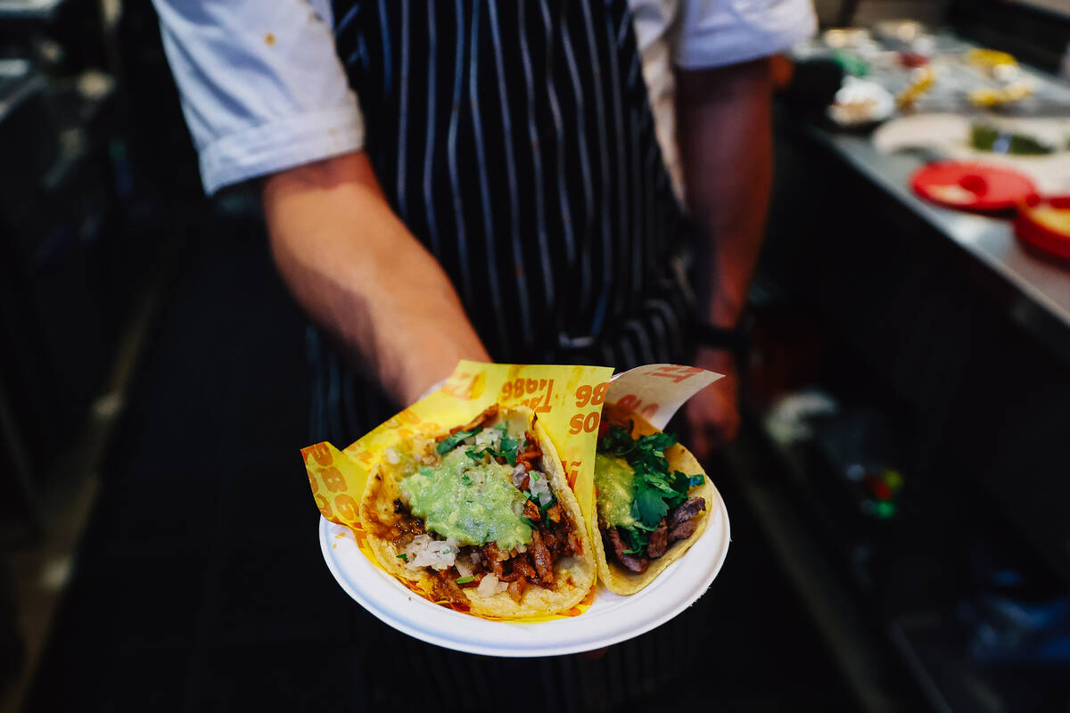 Chef Jorge Alvarez-Tostado holds up tacos at Tacos 1986 at The Neighborhood Food Hall in the Re ...