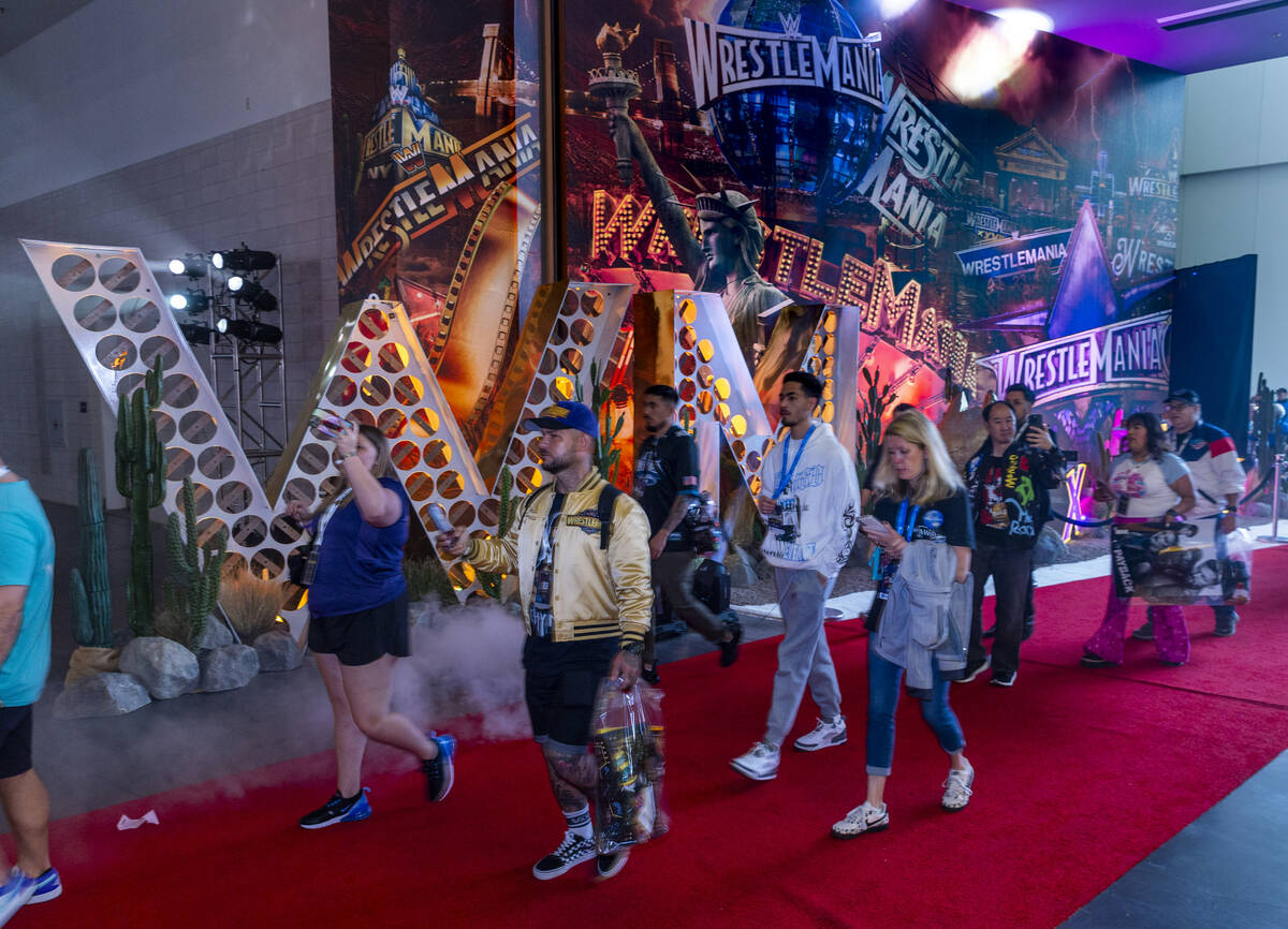 Fans walk into the entrance at WWE World, the Ultimate Fan Experience with a variety of retail ...