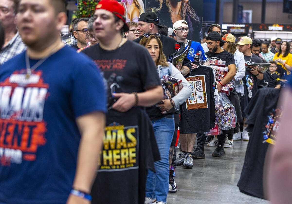 Fans stand in line to pay for merchandise at the WrestleMania Superstore within WWE World, the ...