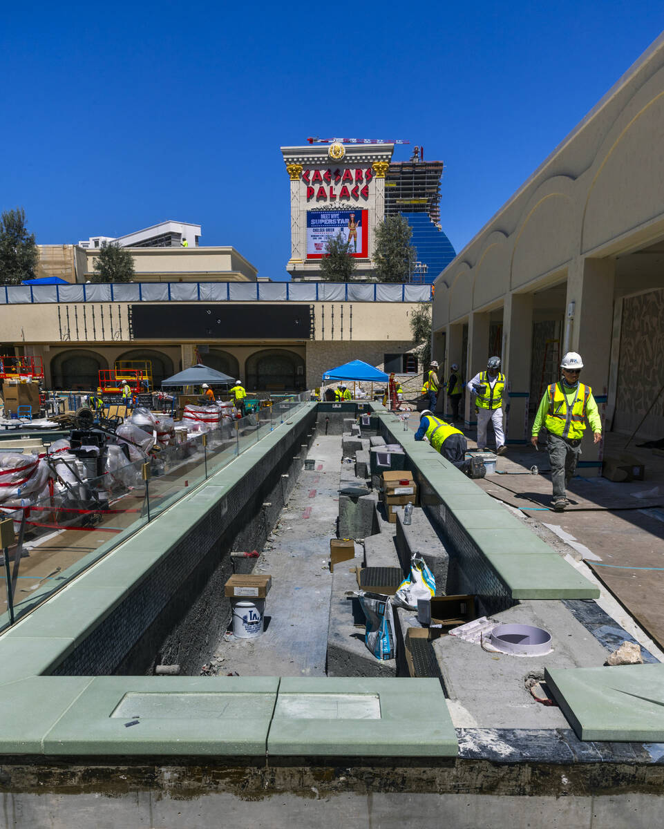 A plunge area is being completed between cabanas and several pools as construction continues on ...
