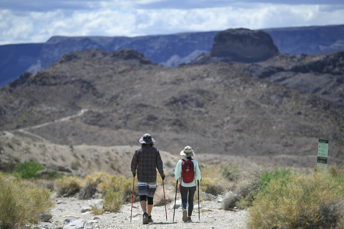 Hikers head out on the Arizona Hot Springs trail south of the Hoover Dam before the trails are ...